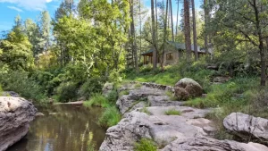 Wooded Christopher Creek home with flowing water, fictionalized residence.