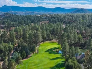 Golf course fairway lined with tall ponderosa pines in the Chaparral Pines community in Payson, Arizona