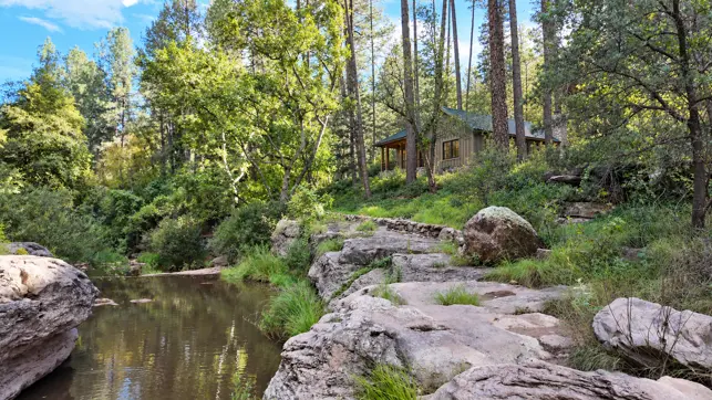Wooded Christopher Creek home with flowing water, fictionalized residence.