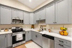 Remodeled gray kitchen with updated cabinets, countertops and appliances